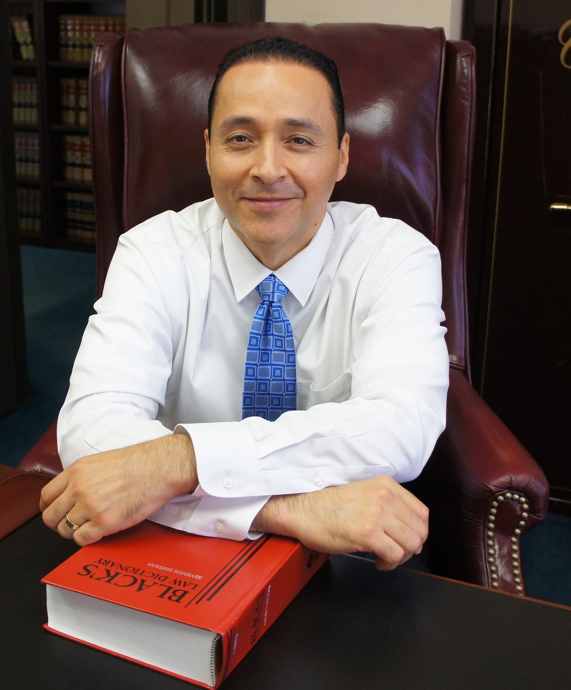 Attorney Alejo Lugo at his desk in the Riverside office