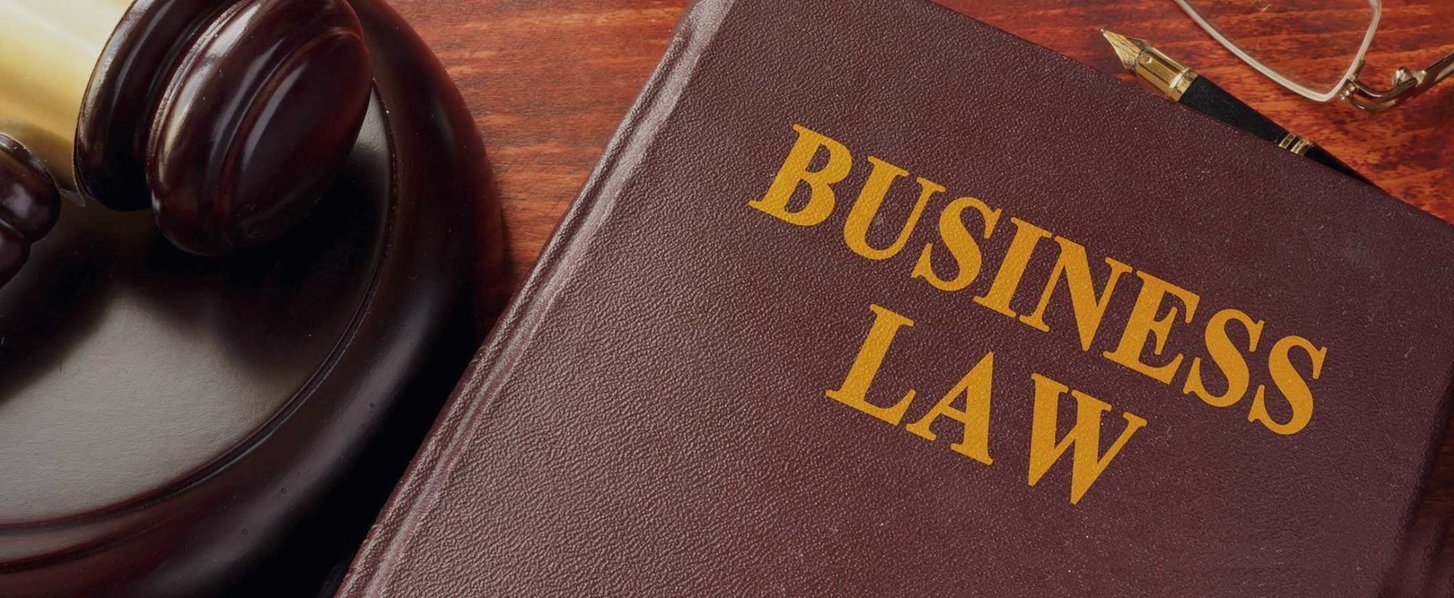 A business law reference book beside a gavel, used in corporate guidance and incorporations