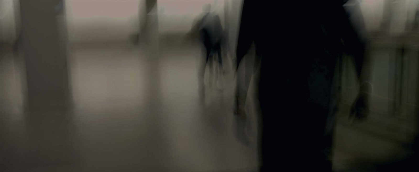 A shadowed figure standing in a doorway, the threat in a domestic violence case