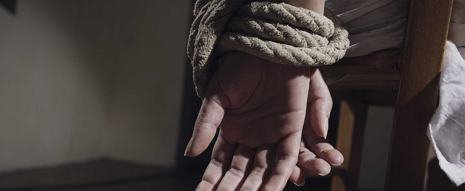 Hands bound with rope and tied to a chair in a kidnapping case