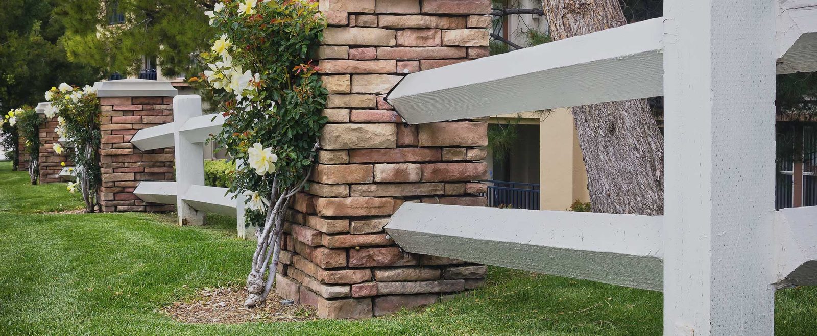 A white picket fence in front of a family home, property divided as community property