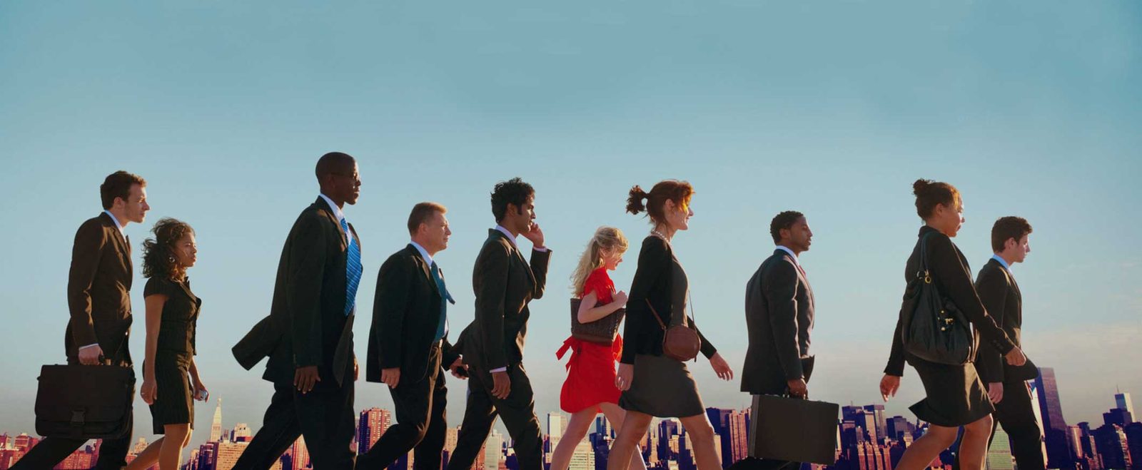 Professionals walking with briefcases, arriving through employment-based immigration