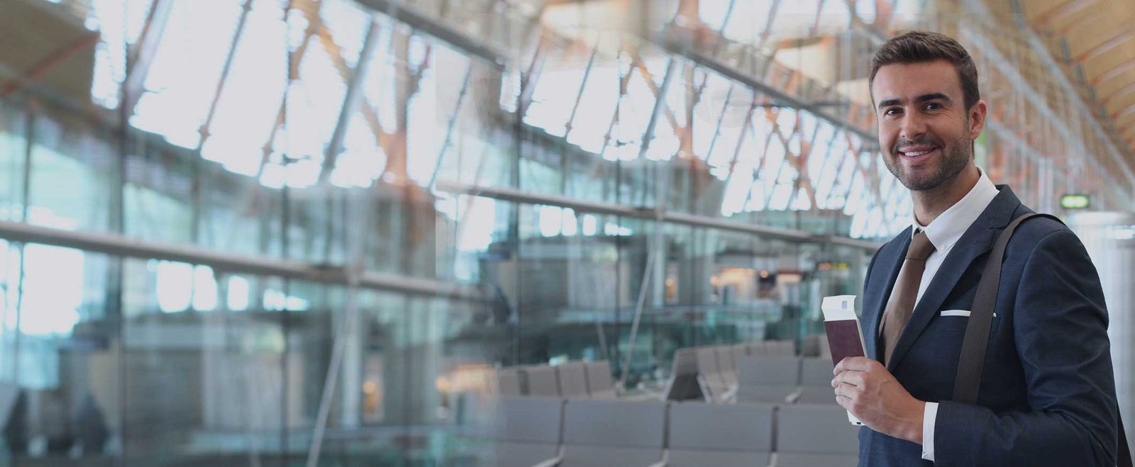 A man carrying his passport through an airport after being granted a work visa
