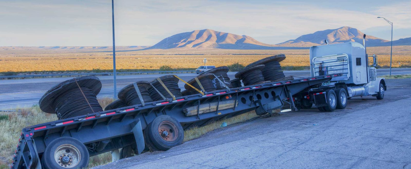 An overturned semi-truck trailer blocking a highway after a truck accident